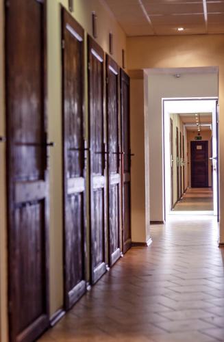 an empty hallway with wooden doors in a building at Boutique Hostel in Łódź