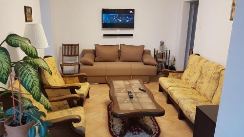 a living room with a couch and a coffee table at Eden Apartament in Bucharest