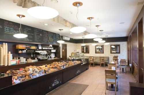 a fast food restaurant with a counter with pastries at Hostel Liberty in Kaunas
