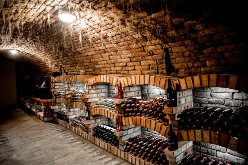 a room filled with lots of bottles of wine at Berger Pince-vendégház, Hajósi pincék in Hajósi Pincék
