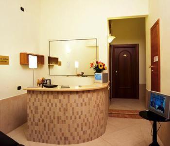 a hotel room with a computer desk and a large mirror at Hotel Moscatello in Rome