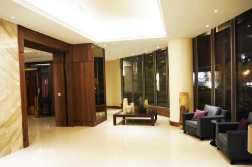 a lobby with couches and chairs in a building at Beitou Hot Spring Resort in Taipei