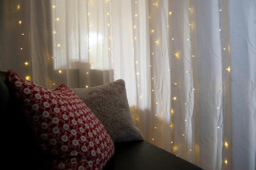 two pillows sitting on a table in front of a window with lights at Villa Luna Lombarda in Salò