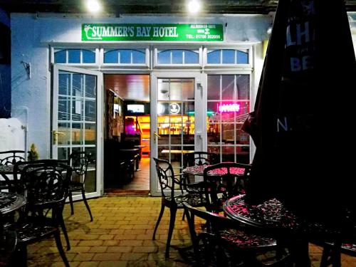 a tables and chairs in front of a restaurant at Summer's Bay in Rothesay