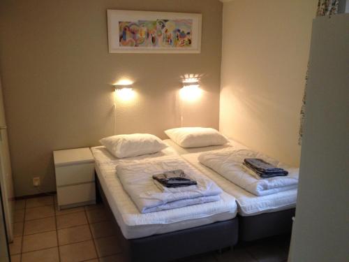 a hotel room with two beds with towels on them at Vakantiehuis Lochem in Lochem