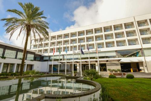 a large building with a large clock on top of it at Azoris Royal Garden – Leisure & Conference Hotel in Ponta Delgada