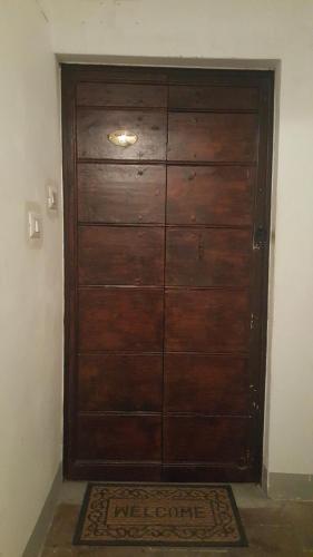 a large wooden door in a room with a rug at Vicolo Vecchio 59 in Rome