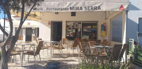 a restaurant with tables and chairs in front of a building at Nave Redonda do Cerro – Countryside & Nature in Nave Redonda