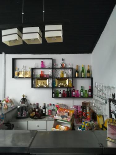 a kitchen with a counter top with bottles on the shelves at Hotel Cristo Rei in Porto