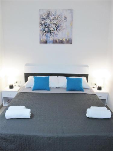 a bedroom with a bed with two towels on it at SeaEye Trogir in Trogir