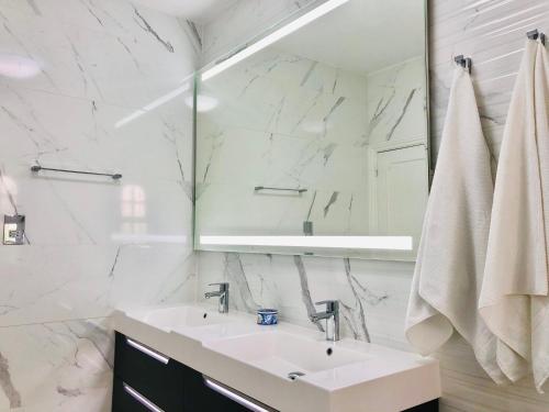 a white bathroom with a sink and a mirror at Luxury Casa da Fonte - Private Heated Pool in Faro