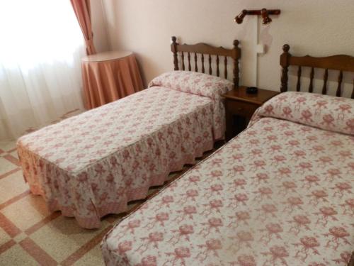 2 camas en una habitación de hotel con en Hostal Restaurante San Poul, en Consuegra