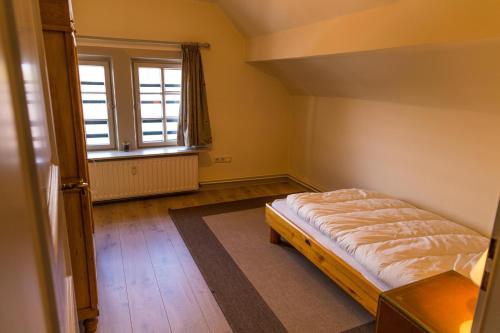 a small bedroom with a bed and a window at Forsthaus Edelburg Ferienhaus in Hemer