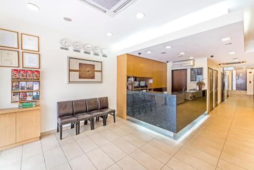 a lobby of a hospital with leather chairs and a counter at Hotel 81 Balestier in Singapore