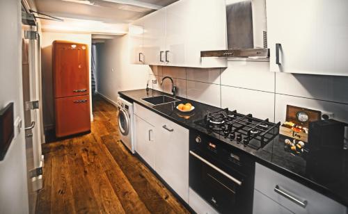 a kitchen with a stove and a counter top at Beautiful DutchHouse Centrum in Amsterdam