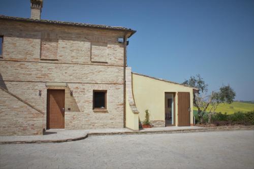 a brick building with a door on the side of it at B&B Casa Fanny Riviera Del Conero in Loreto