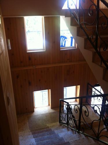 a staircase in a house with three windows at Villa Ureki in Ureki