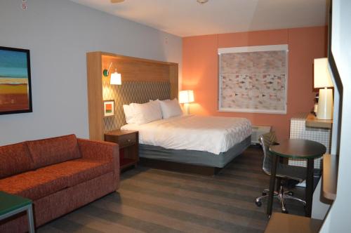 a hotel room with a bed and a couch at Holiday Inn Odessa by IHG in Odessa