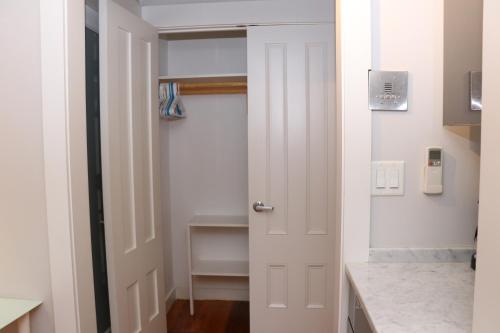 a white door in a room with a hallway at Charming & Stylish Studio on Beacon Hill #15 in Boston