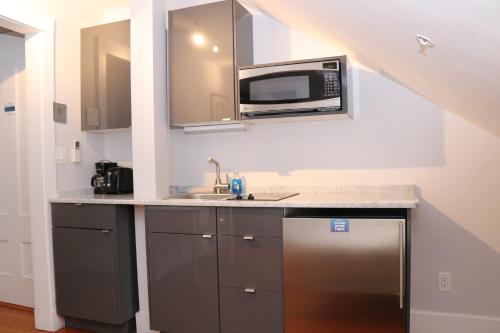 a kitchen with a microwave and a sink at Charming & Stylish Studio on Beacon Hill #15 in Boston