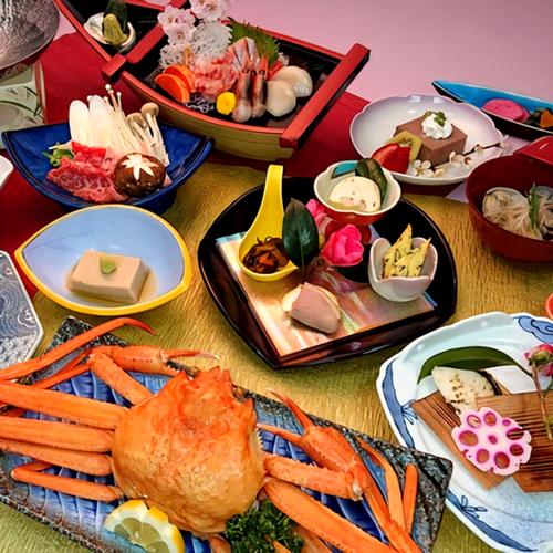 a table topped with plates of food with carrots and other foods at Hotel Tetora Resort Tsuruoka in Tsuruoka