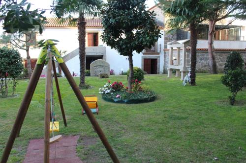 a tripod in the yard of a house at Turismo Homes Solar Do Areal in Braga