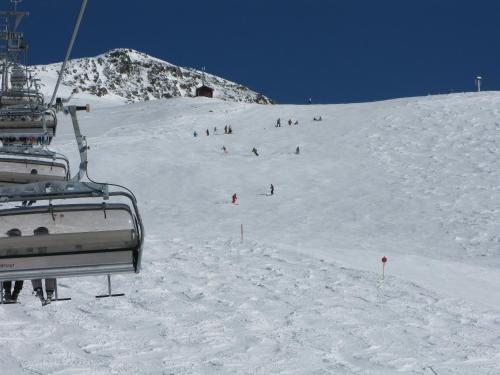a group of people skiing down a snow covered slope at Alpenhotel Laurin in Hochgurgl
