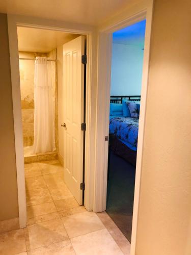 an open door to a bedroom with a bed at Kona Magic Honu Room in Kailua-Kona