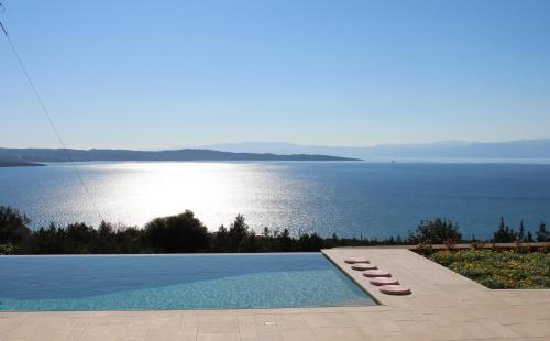 a swimming pool with a view of the water at IRIDA in Koilás
