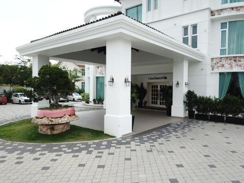 a white building with a pavilion in front of it at Casa Bianca in Kluang