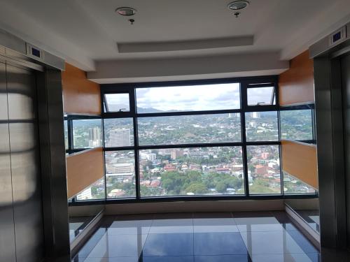 an empty room with a large window in a building at KC Studio 6 at Horizon 101 Cebu in Cebu City