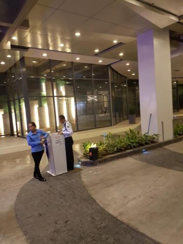 two people standing in front of a building at KC Studio 6 at Horizon 101 Cebu in Cebu City