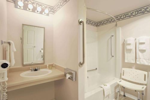 a white bathroom with a sink and a shower at Super 8 by Wyndham West Kelowna BC in West Kelowna