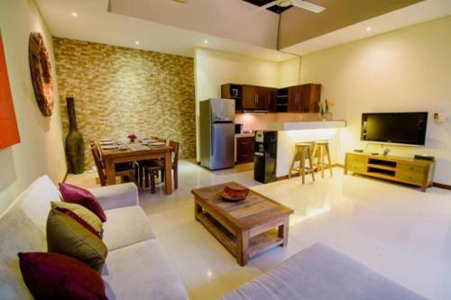 a large living room with a couch and a table at Villa Raka Managed by Manara in Legian