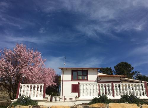 a white house with a white fence and a tree at Il Profumo della Natura B&B in Oriolo Romano
