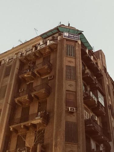 a tall building with balconies on top of it at Cecilia Hostel in Cairo