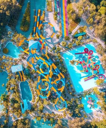 an aerial view of a water park with a roller coaster at By The Sea Beach Front Apartment in Batu Ferringhi