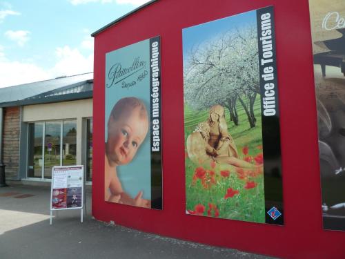 a billboard with a picture of a baby in a field of flowers at Chez Isa et Christophe in Mogeville