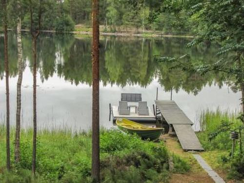 a dock with a yellow boat next to a dockermott at Holiday Home Lokki by Interhome in Vesijako