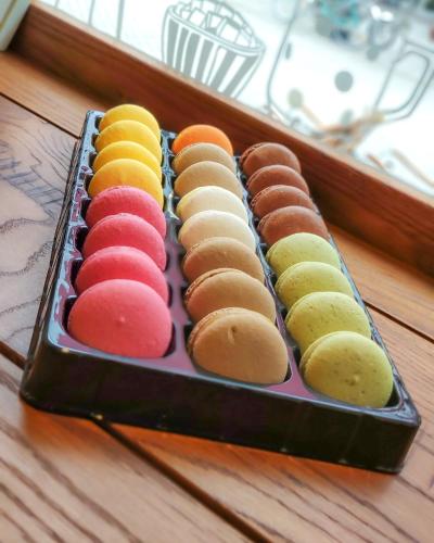 a tray of colored cookies sitting on a table at JAM Luxury Apartment in Győr