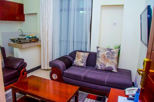 a living room with a purple couch and a table at Sheratton Regency Hotel in Mombasa
