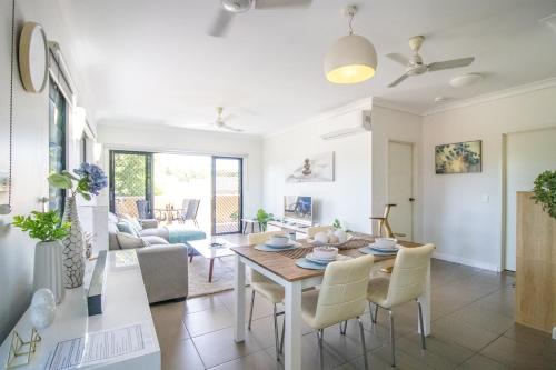 a dining room and living room with a table and chairs at ZEN QUEST - The NOMADS PAD Near Nightcliff Markets & Sunset Foreshore in Nightcliff