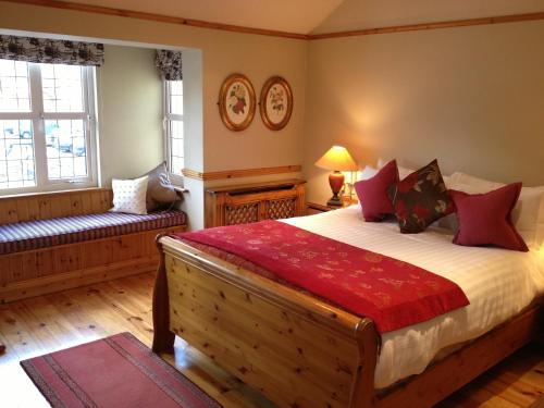 a bedroom with a large bed and a couch at Copper Kettle B&B in Killarney