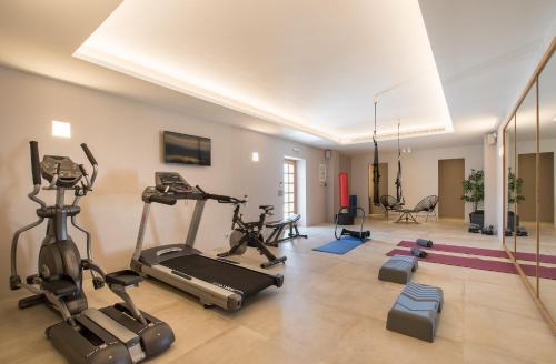 a gym with treadmills and exercise bikes in a room at BASSA MAINA Villas & Suites in Areopolis
