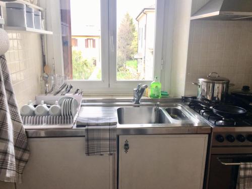 a kitchen counter with a sink and a window at Re Monza appartamenti in villa comodi per Milano in Monza