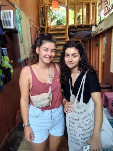 two girls are standing next to each other at Darpins Guesthouse in Dauin