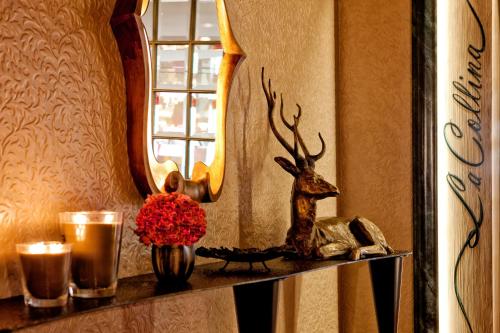 a shelf with a deer head and a mirror at Tschuggen Grand Hotel - The Leading Hotels of the World in Arosa