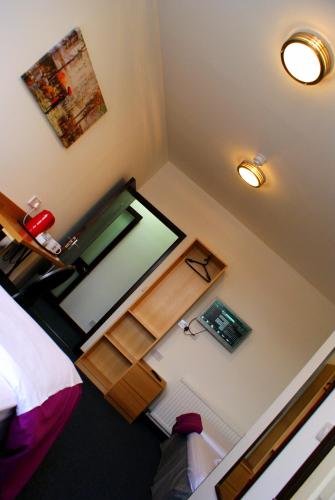 an overhead view of a bedroom with a bath tub at The Hindes Hotel in Harrow