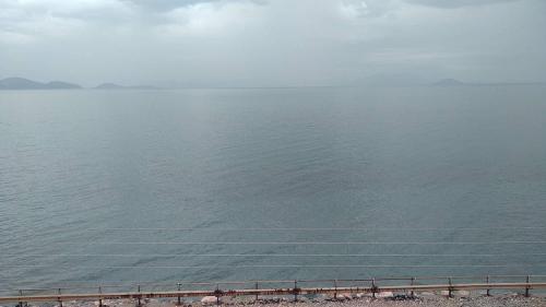a body of water with a fence in front of it at Violetta Studios in Paralion astros