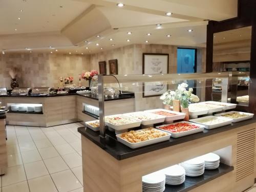 a buffet line in a restaurant with food on display at Iris Hotel & Spa in Canakkale